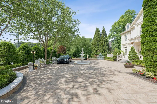 a view of a white house with a sink and yard