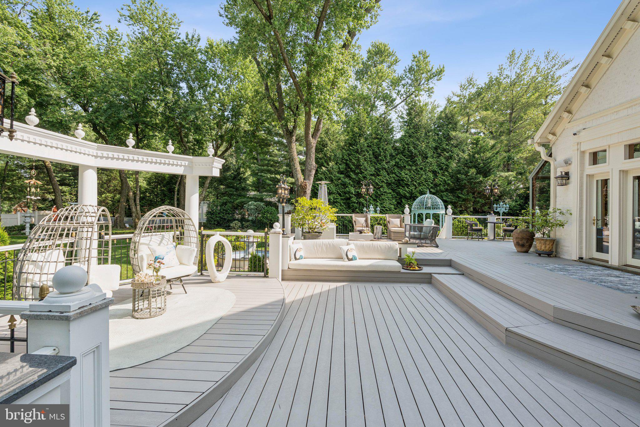 423 Seneca Road Great Falls, VA 22066 - Photo 46 of 55 a view of a patio with couches table and chairs and wooden floor
