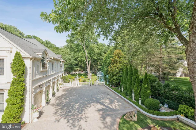 a view of a house with swimming pool and sitting area