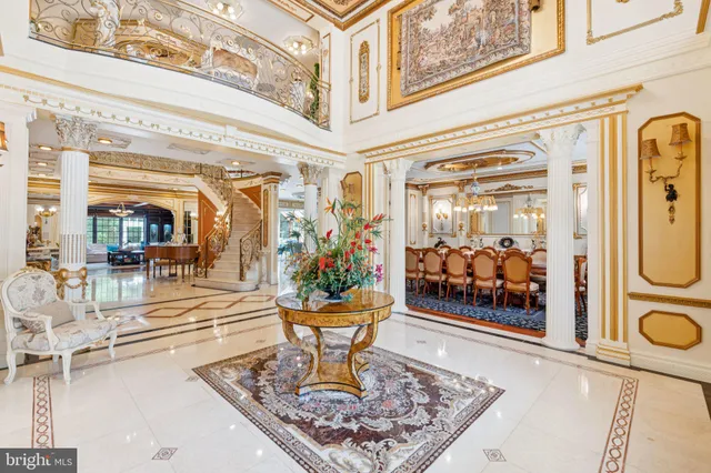 a dining room with furniture and a chandelier