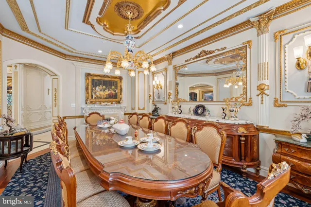 a view of a dining room with furniture a chandelier and wooden floor