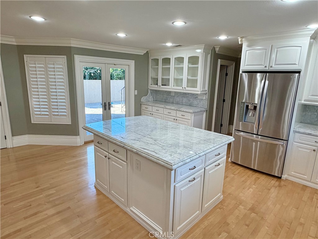 5243 East Arbor Road Long Beach, CA 90808 - Photo 11 of 46 a kitchen with stainless steel appliances granite countertop a refrigerator a stove and a wooden floors