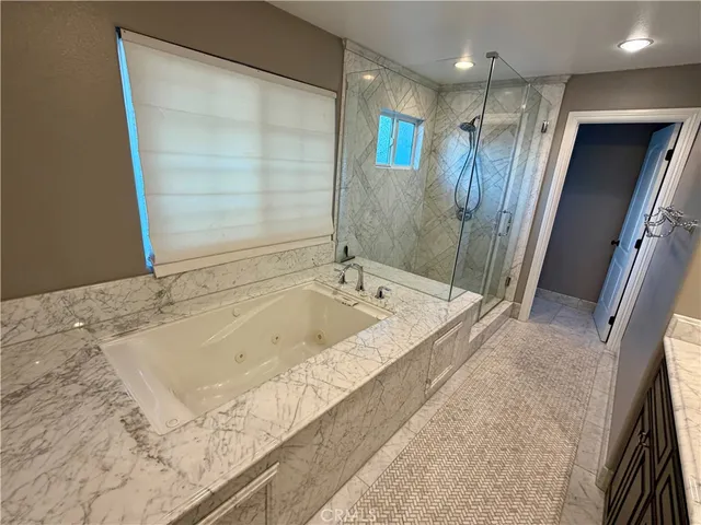 a bathroom with a bathtub and a shower
