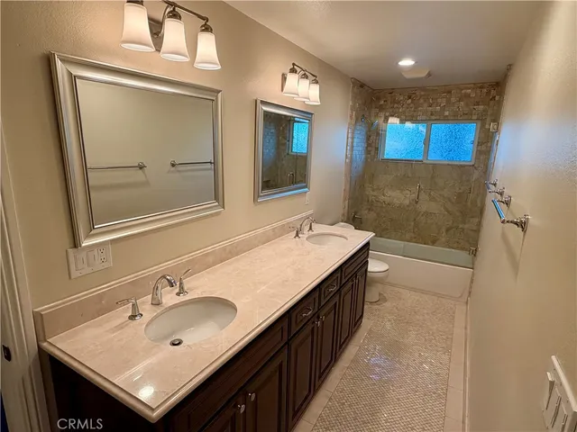 a bathroom with a sink a mirror and a shower
