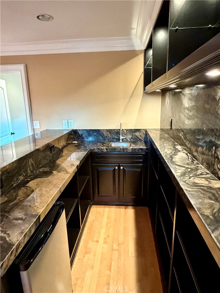 5243 East Arbor Road Long Beach, CA 90808 - Photo 35 of 46 a kitchen with stainless steel appliances granite countertop a sink and a stove