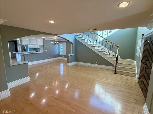 a view of entryway and hall with wooden floor