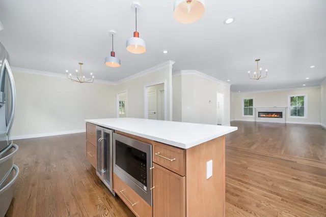a kitchen with a stove and wooden floor