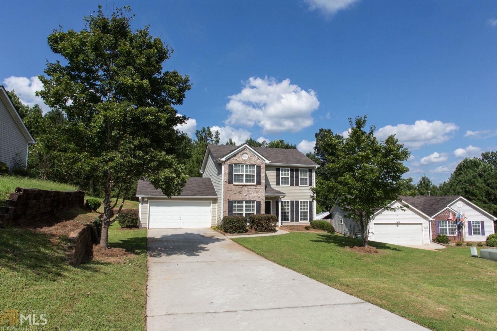 4532 Raptor Place Snellville, GA 30039 - Photo 1 of 1 a front view of a house with a yard and garage