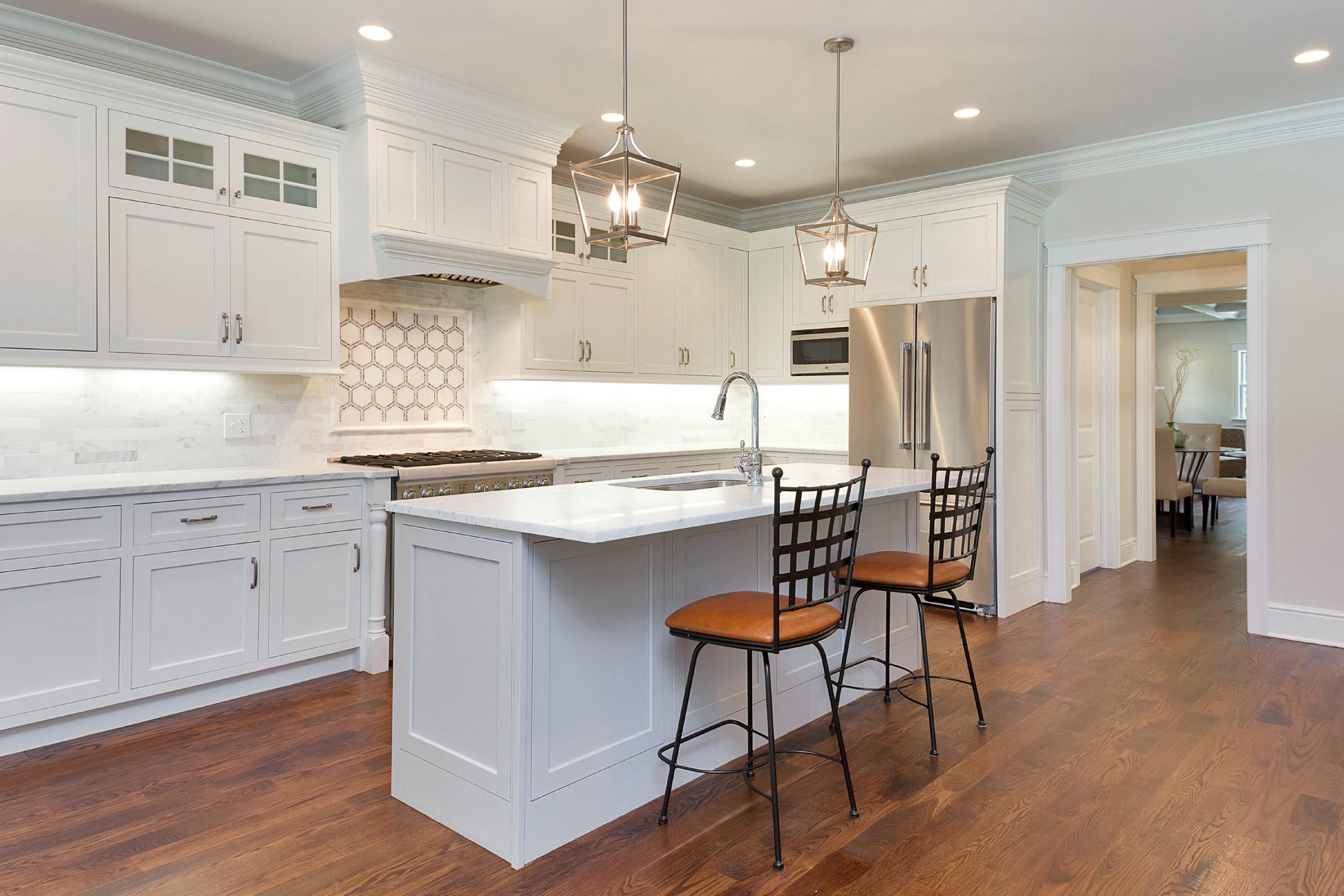 18 Edgewood Road Darien, CT 06820 - Photo 14 of 38 a kitchen with stainless steel appliances kitchen island granite countertop a table chairs refrigerator and sink