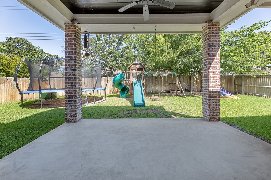 8312 Raintree Drive College Station, TX 77845 - Photo 26 of 30 Covered patio with a concrete surface and brick columns, overlooking a fenced backyard with a manicured lawn