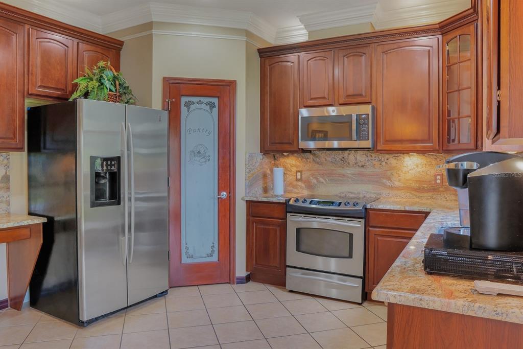 124 Spring Glen Drive DeBary, FL 32713 - Photo 13 of 40 a kitchen with stainless steel appliances granite countertop a refrigerator and a stove