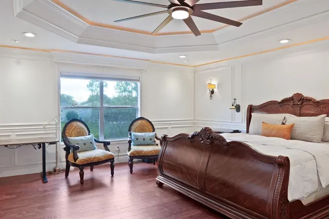 a bedroom with a bed and a chandelier