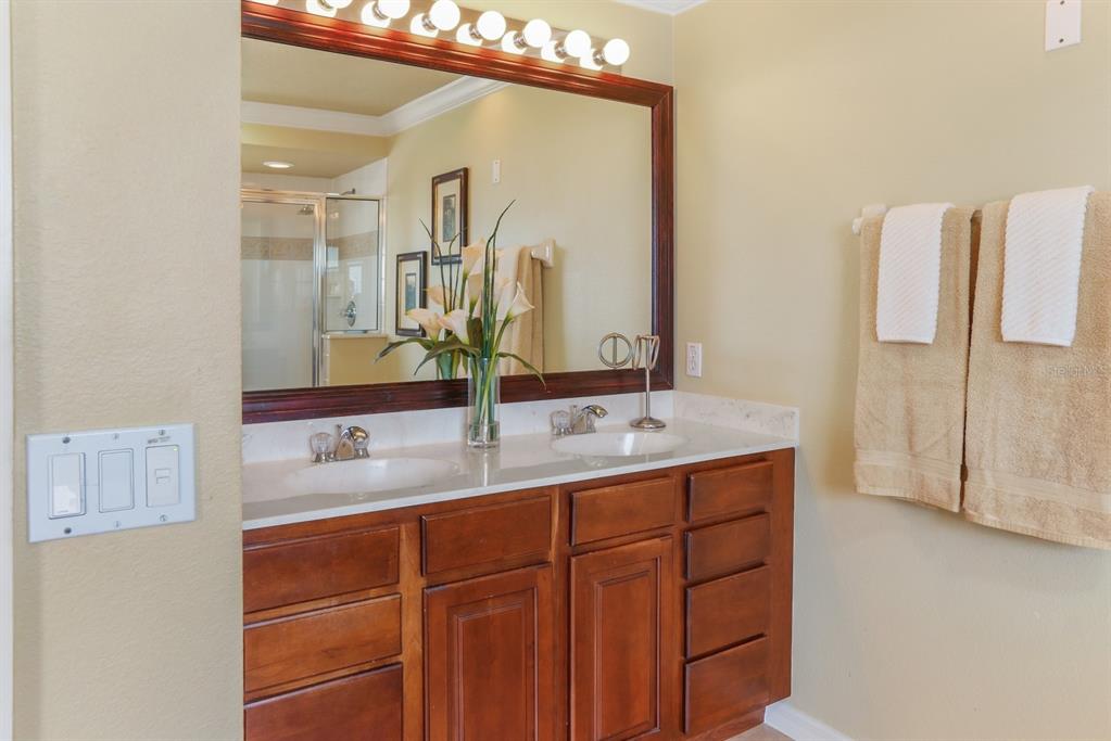 124 Spring Glen Drive DeBary, FL 32713 - Photo 30 of 40 a bathroom with a double vanity sink and mirror