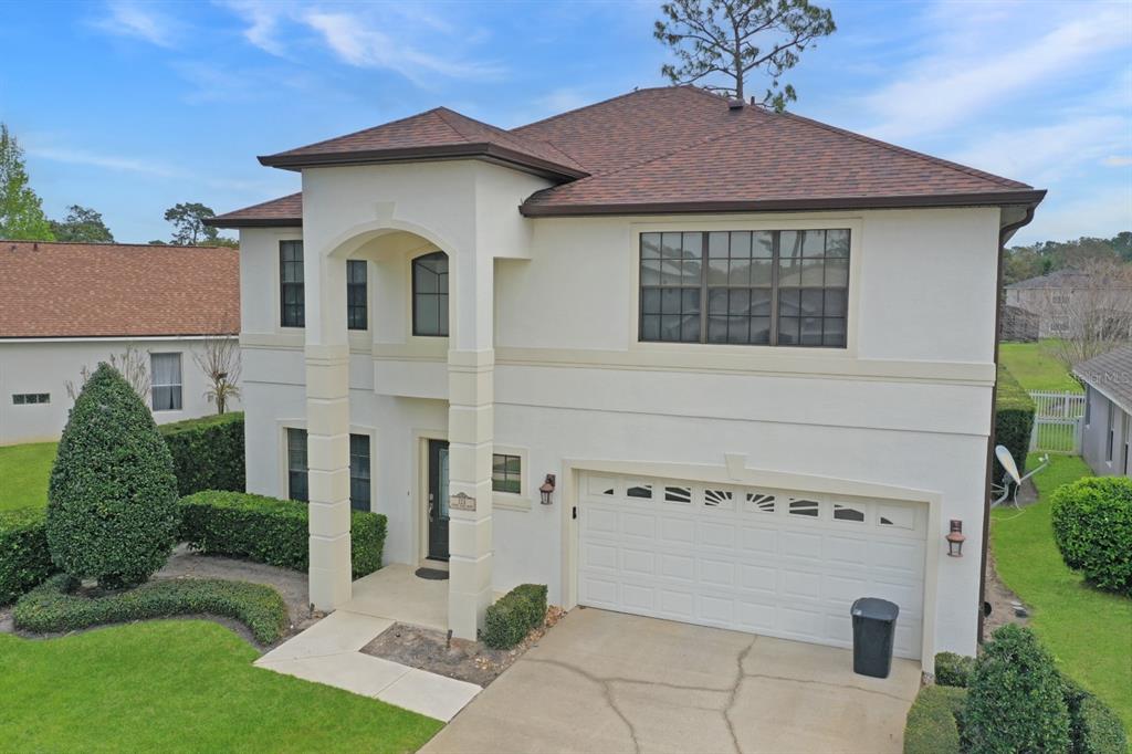 124 Spring Glen Drive DeBary, FL 32713 - Photo 3 of 40 a white house with a small yard and plants
