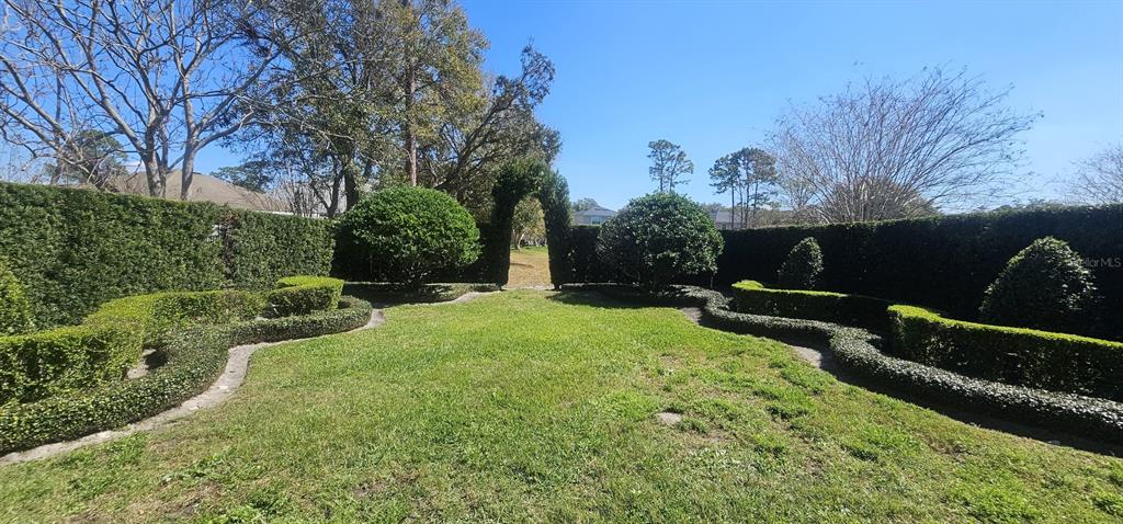 124 Spring Glen Drive DeBary, FL 32713 - Photo 35 of 40 a view of a garden with a bench