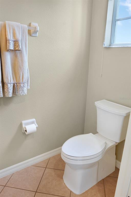 124 Spring Glen Drive DeBary, FL 32713 - Photo 9 of 40 a white toilet sitting next to a bathroom sink