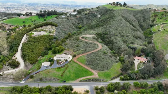 an aerial view of a residential houses with outdoor space and street view