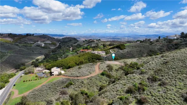 an aerial view of a house with a yard and trees