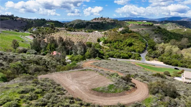 a view of a big yard with lots of green space