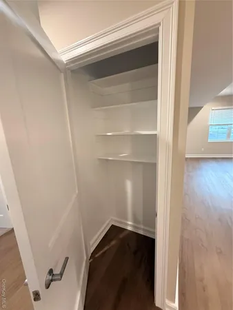 a view of walk in closet with empty racks