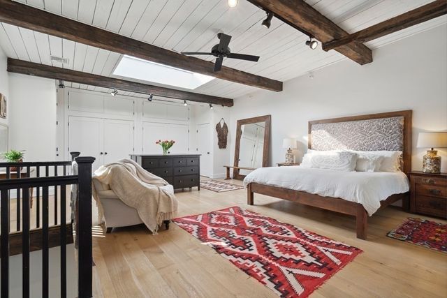 a bedroom with furniture and a rug