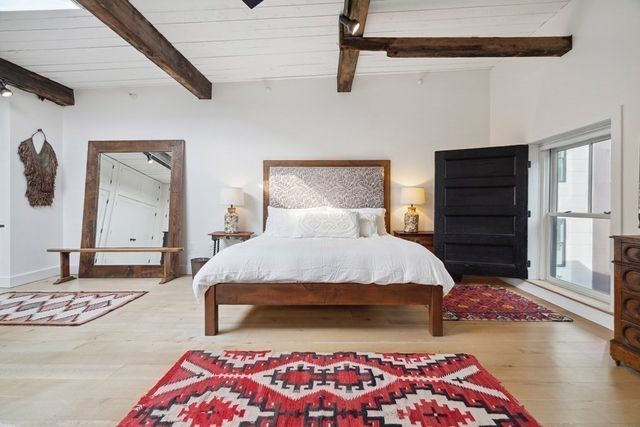 a bedroom with a bed and a dresser