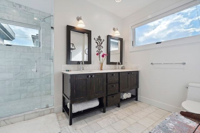a bathroom with a sink a toilet and mirror