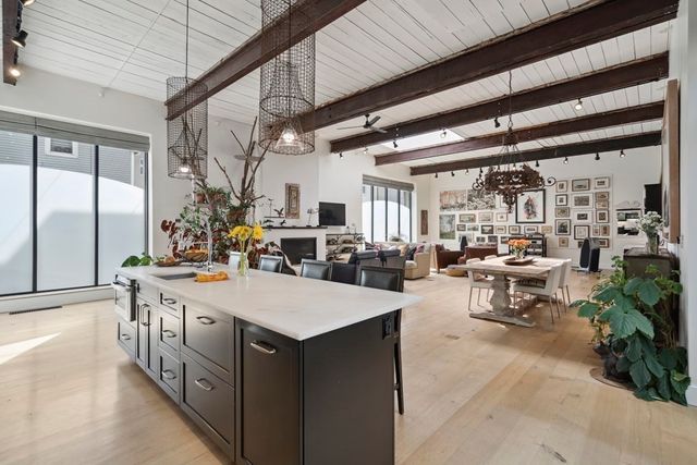 a large white kitchen with a large window