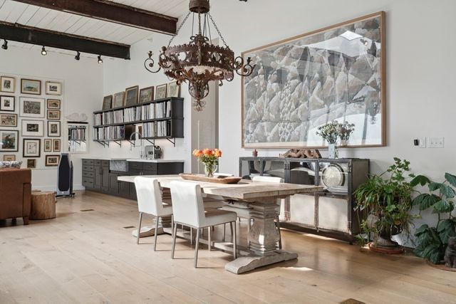 a view of a dining room with furniture and chandelier