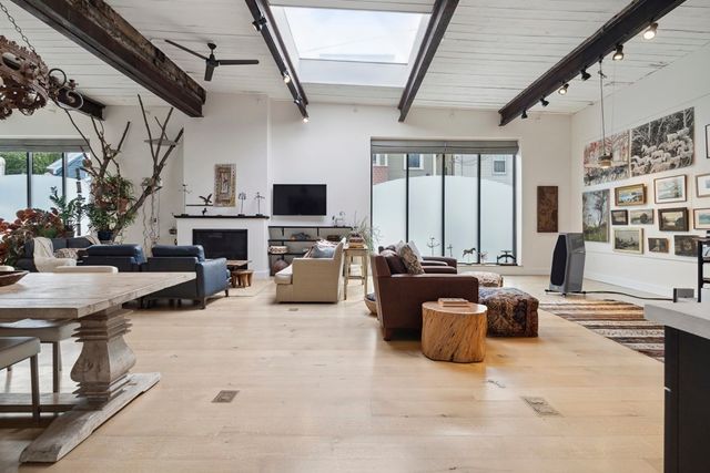 a living room with furniture a fireplace and a flat screen tv