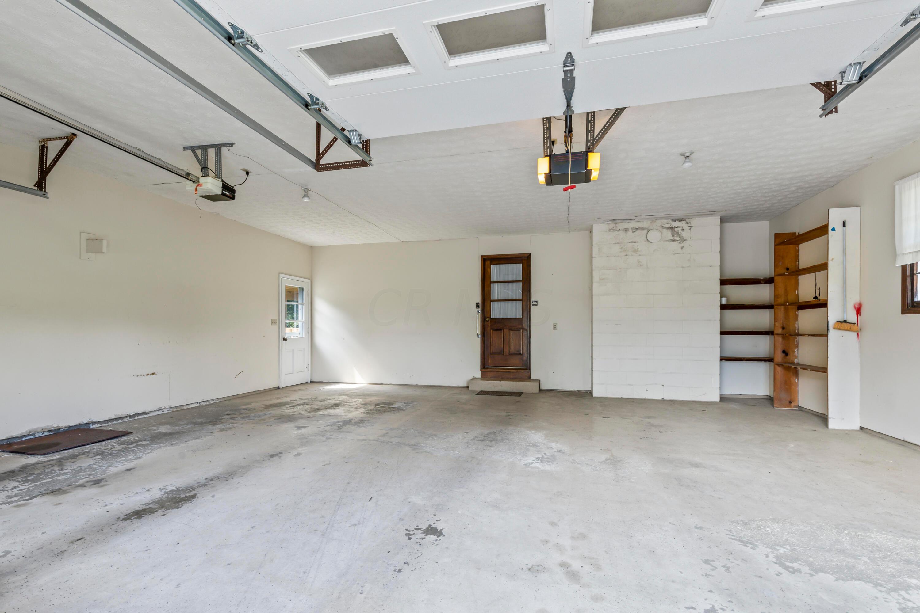 5764 Cheshire Road Galena, OH 43021 - Photo 34 of 59 • 2+ car attached
• Side entry
• (2) service doors
• Genie® electric door opener
• Liftmaster® electric door
opener
• Wall shelves
• Partially finished walls &
ceiling