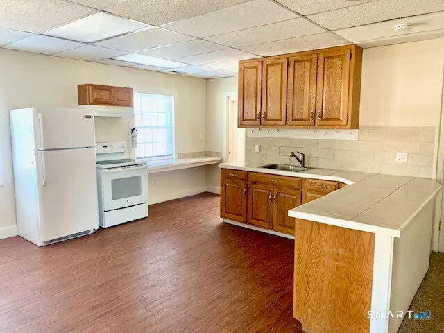 4666 Main Street, Unit 2B Bridgeport, CT 06606 - Photo 2 of 16 a kitchen with a sink a stove and cabinets