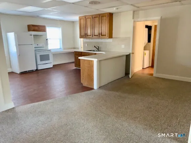 a kitchen with a sink cabinets and wooden floor