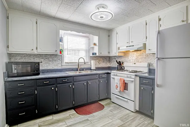 a kitchen with a white cabinets and white appliances