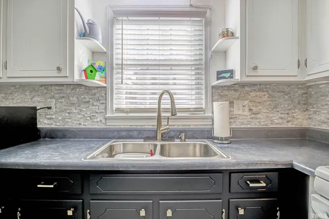 a kitchen with a sink and a window