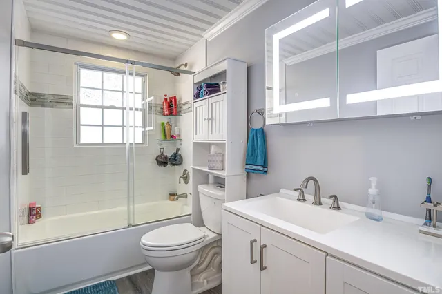 a bathroom with a sink toilet and shower