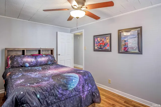 a bedroom with a large bed and a chandelier