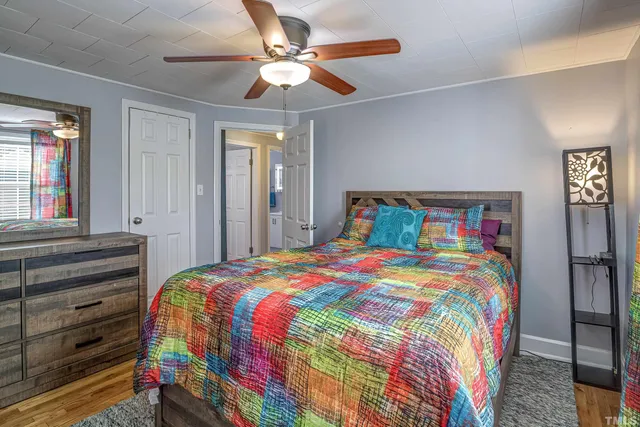 a bedroom with a bed and a chandelier