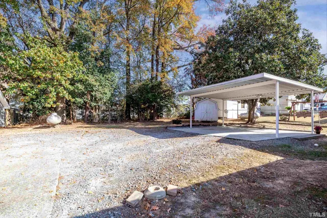 a view of a house with yard and sitting area