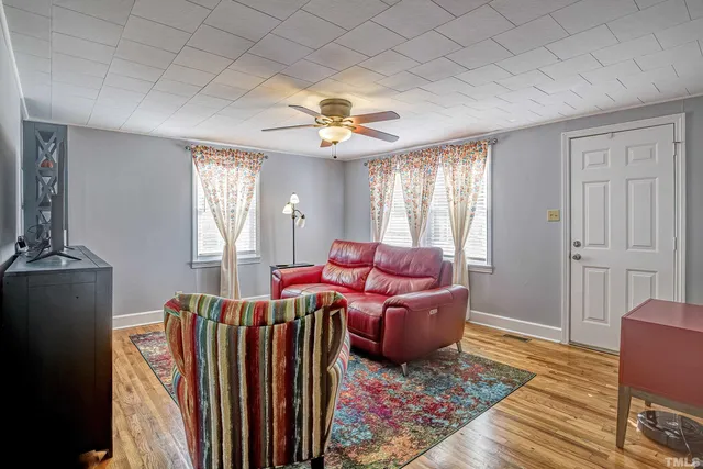 a living room with furniture a rug and a window