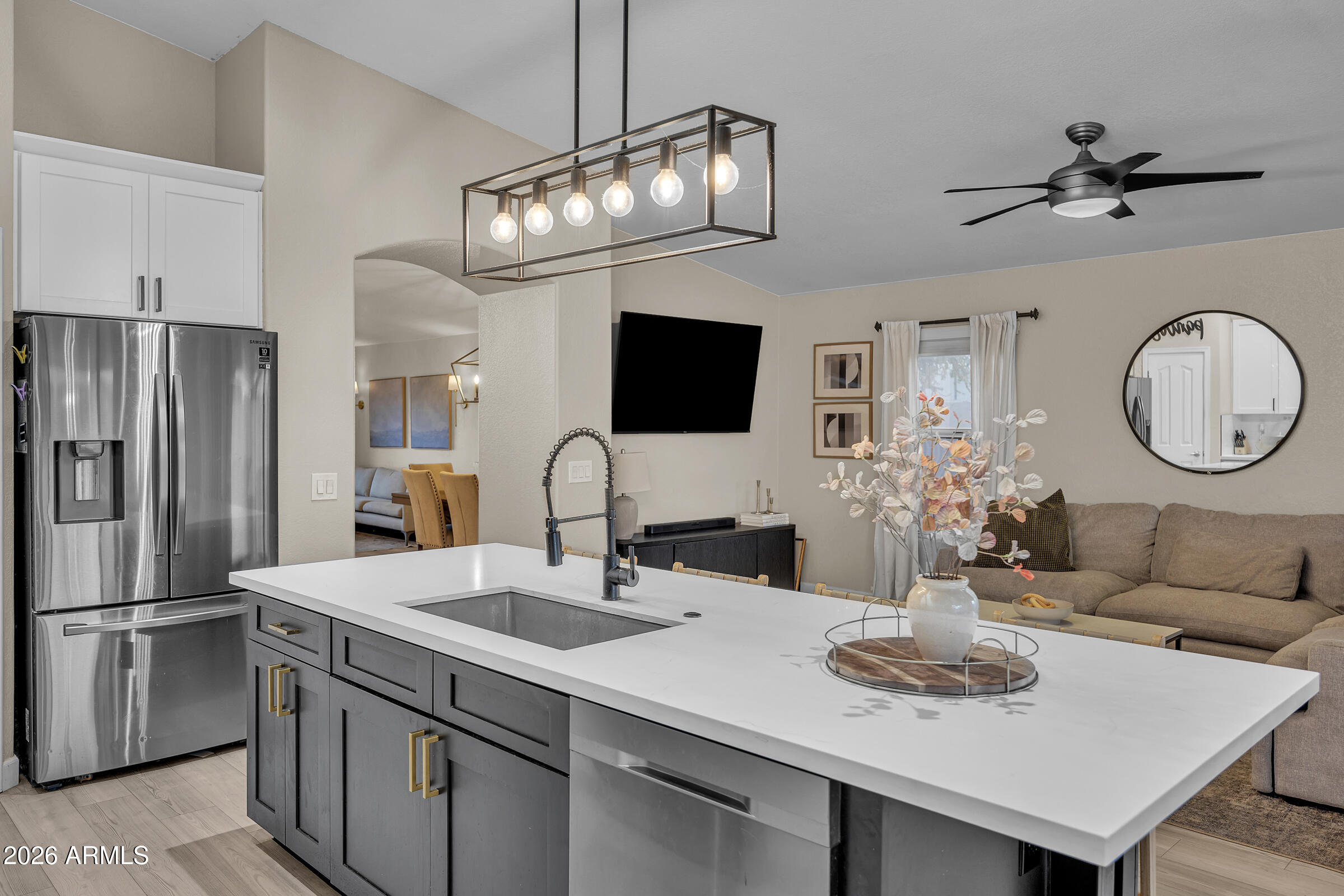 4629 East Gold Poppy Way Phoenix, AZ 85044 - Photo 11 of 46 a kitchen with stainless steel appliances a table chairs and a refrigerator