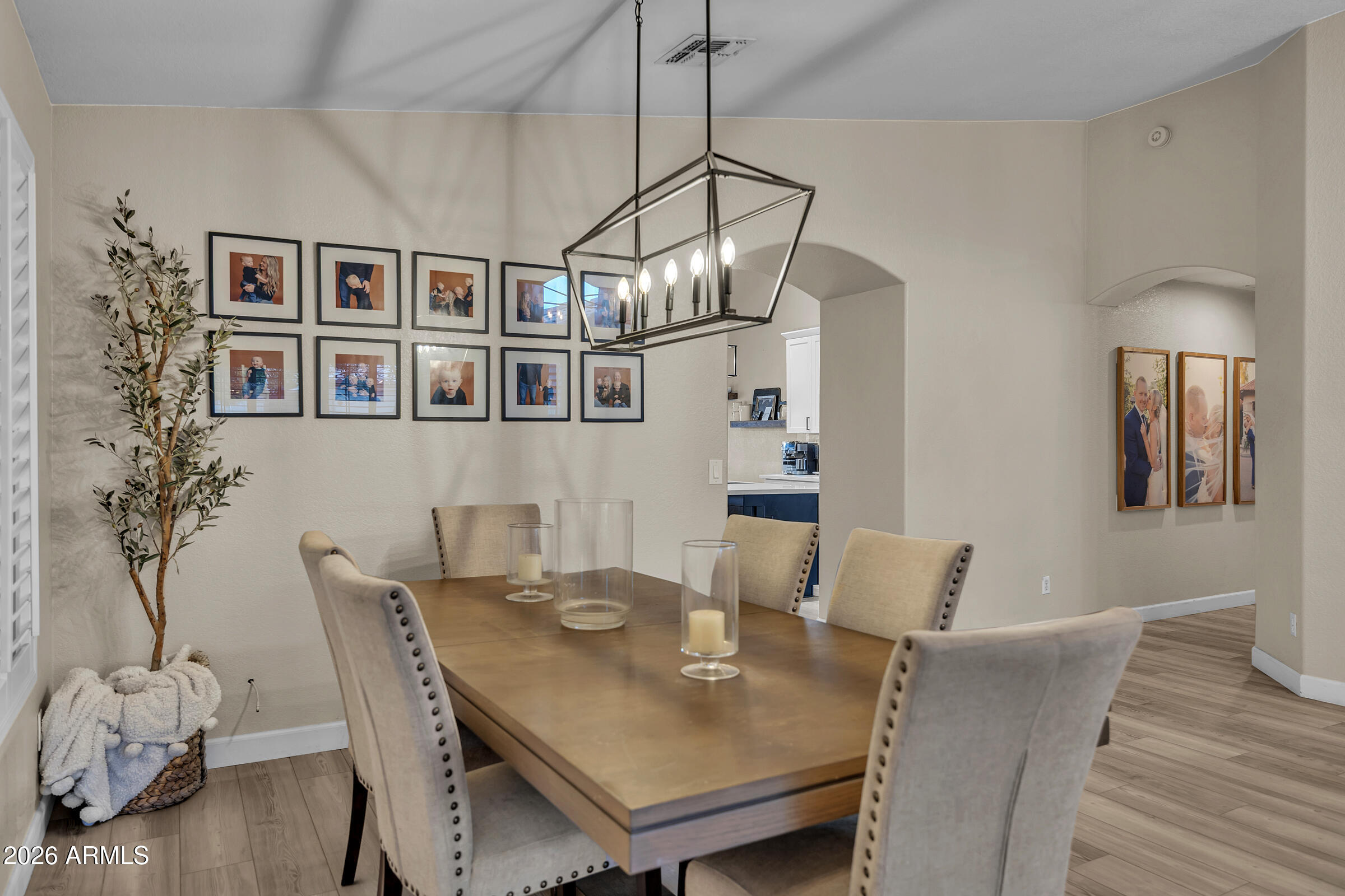4629 East Gold Poppy Way Phoenix, AZ 85044 - Photo 14 of 46 a view of a dining room with furniture wooden floor and chandelier