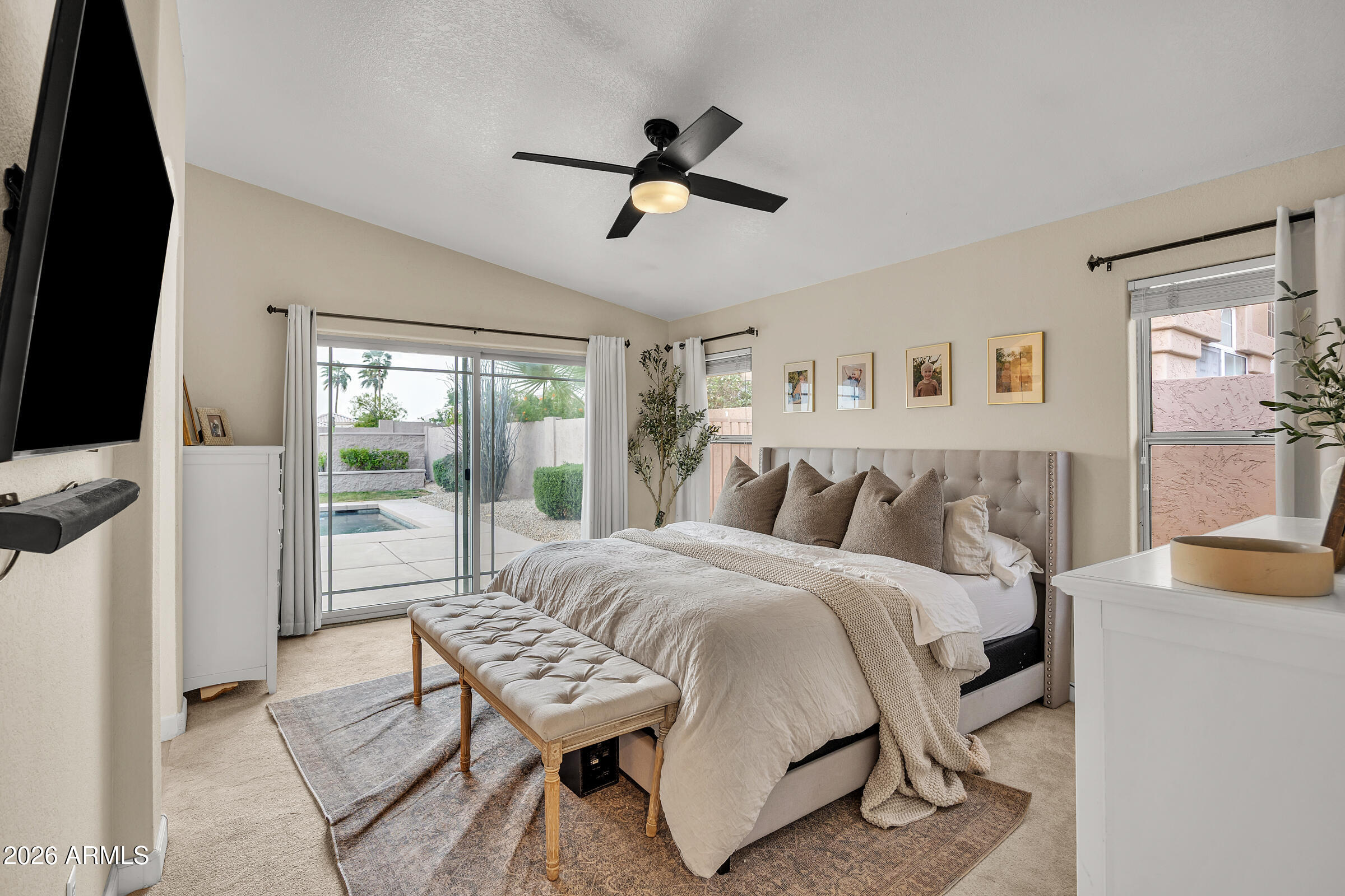 4629 East Gold Poppy Way Phoenix, AZ 85044 - Photo 16 of 46 a bedroom with a bed and a flat tv screen
