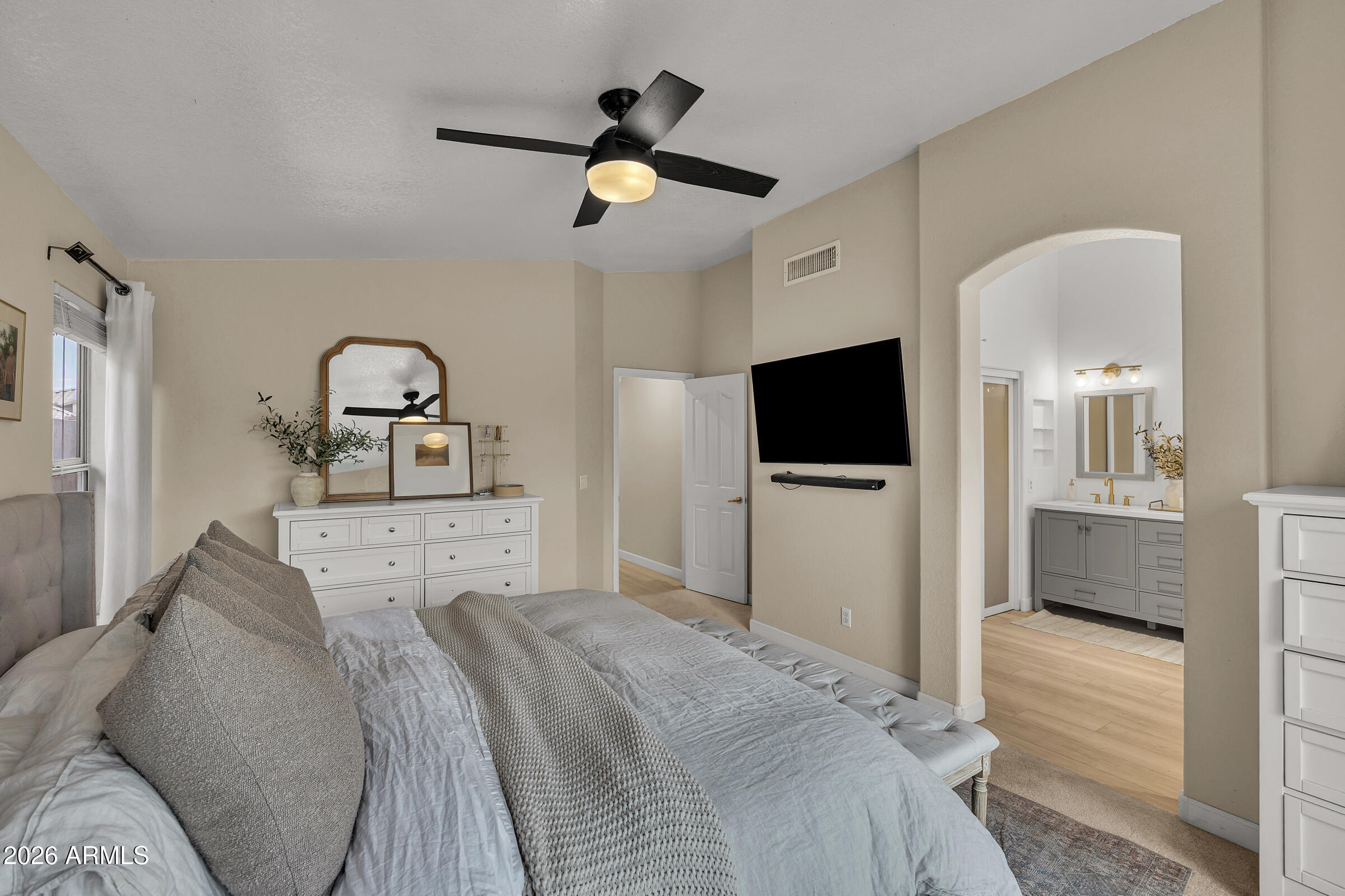 4629 East Gold Poppy Way Phoenix, AZ 85044 - Photo 17 of 46 a bedroom with a bed and a flat screen tv