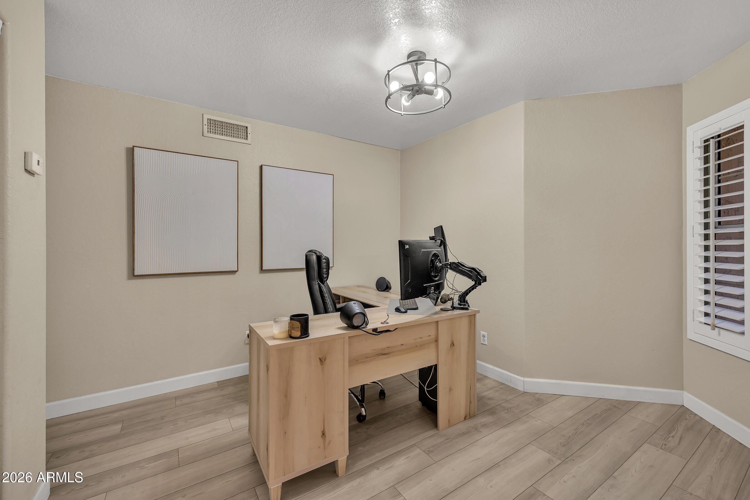 4629 East Gold Poppy Way Phoenix, AZ 85044 - Photo 24 of 46 a view of a workspace with furniture and wooden floor
