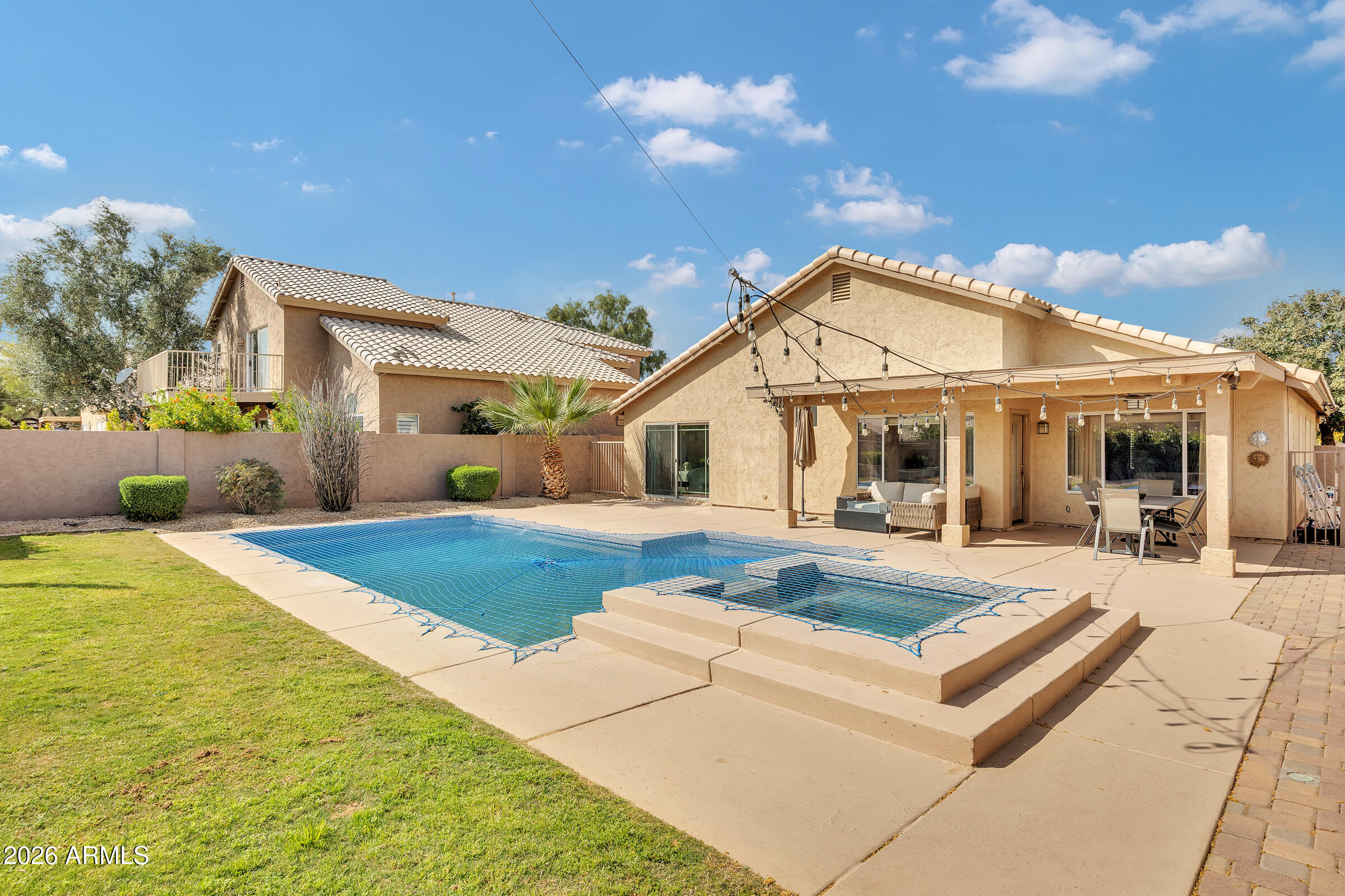 4629 East Gold Poppy Way Phoenix, AZ 85044 - Photo 28 of 46 a front view of a house with swimming pool and furniture
