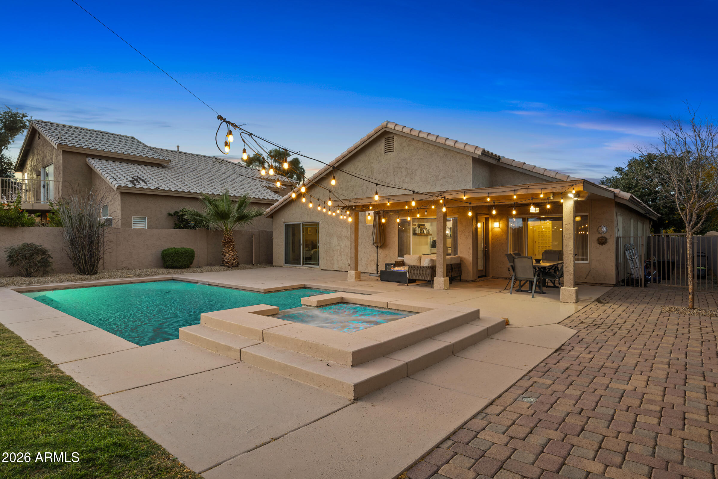 4629 East Gold Poppy Way Phoenix, AZ 85044 - Photo 33 of 46 a patio with a table and chairs under an umbrella