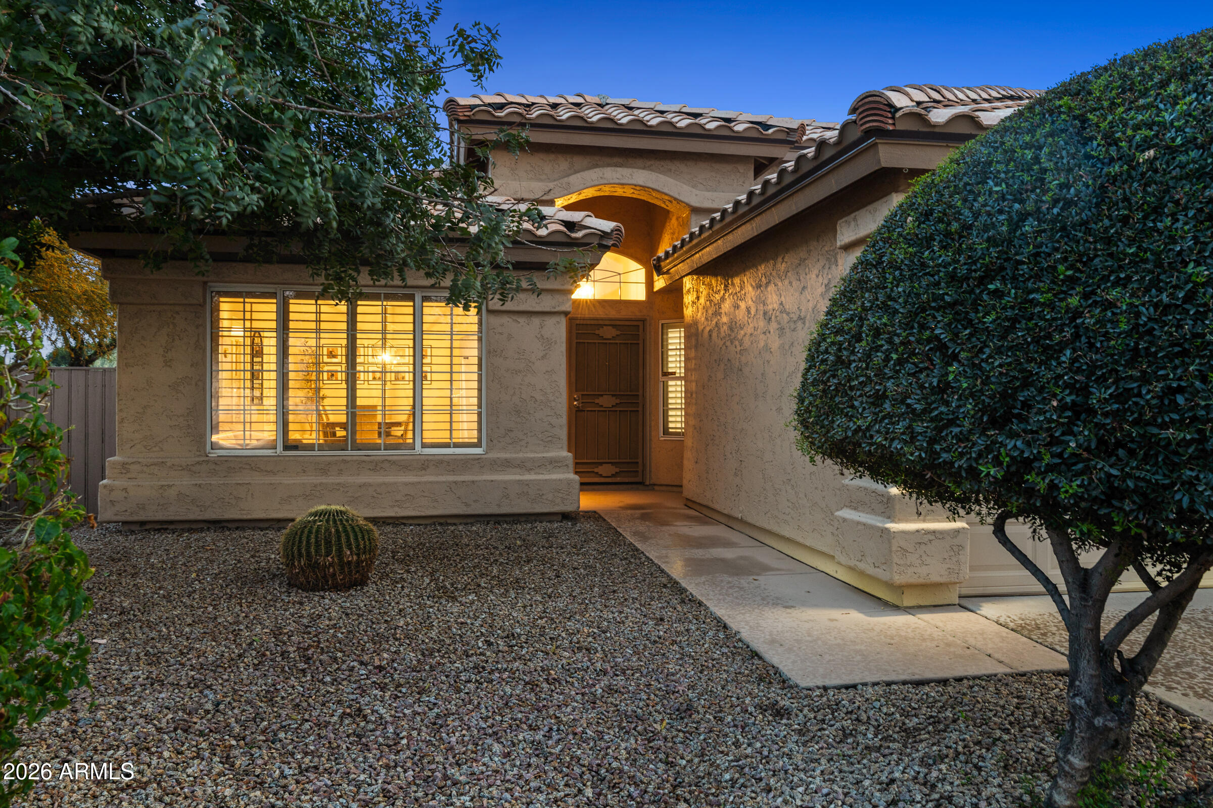 4629 East Gold Poppy Way Phoenix, AZ 85044 - Photo 37 of 46 a front view of a house with garden
