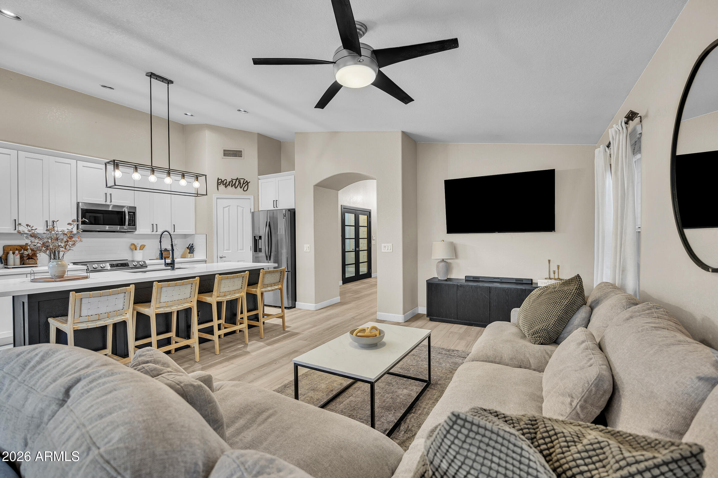 4629 East Gold Poppy Way Phoenix, AZ 85044 - Photo 6 of 46 a living room with furniture kitchen view and a flat screen tv