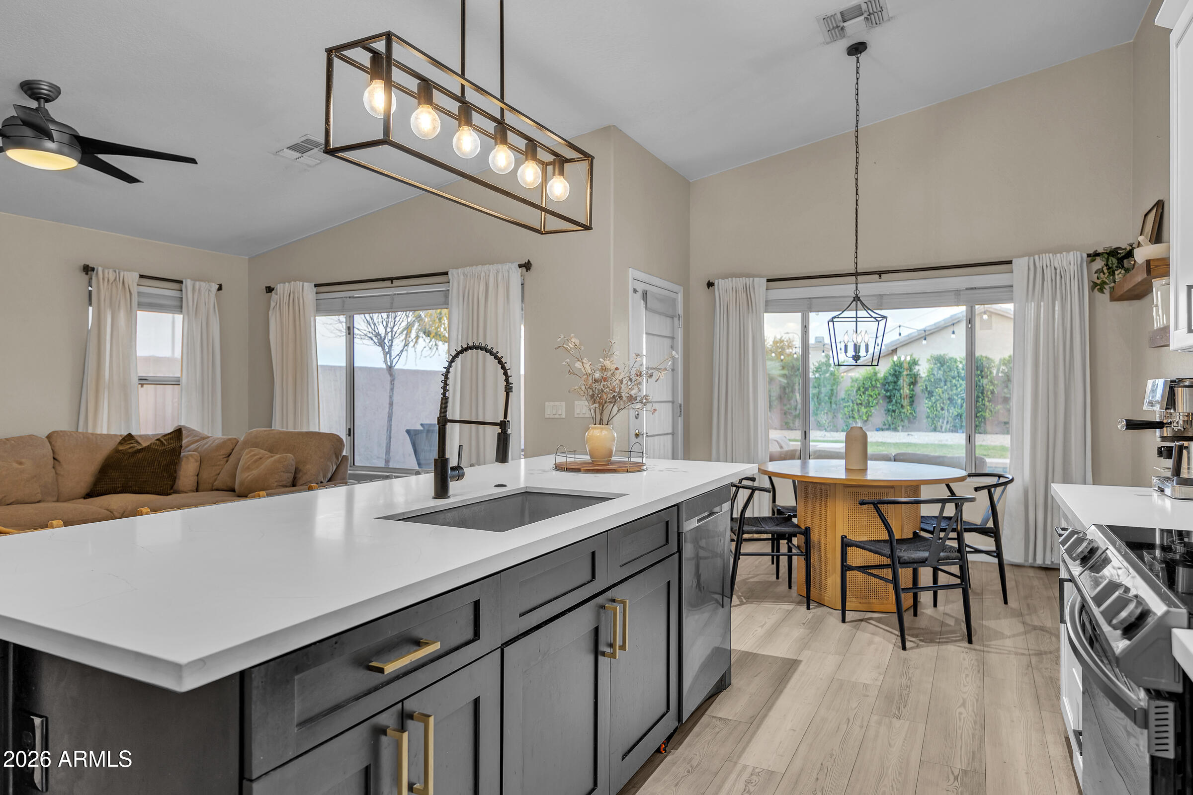 4629 East Gold Poppy Way Phoenix, AZ 85044 - Photo 9 of 46 a kitchen with a sink appliances and a large window
